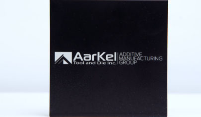 Laser etched block with AarKel Additive Manufacturing Group logo engraged.